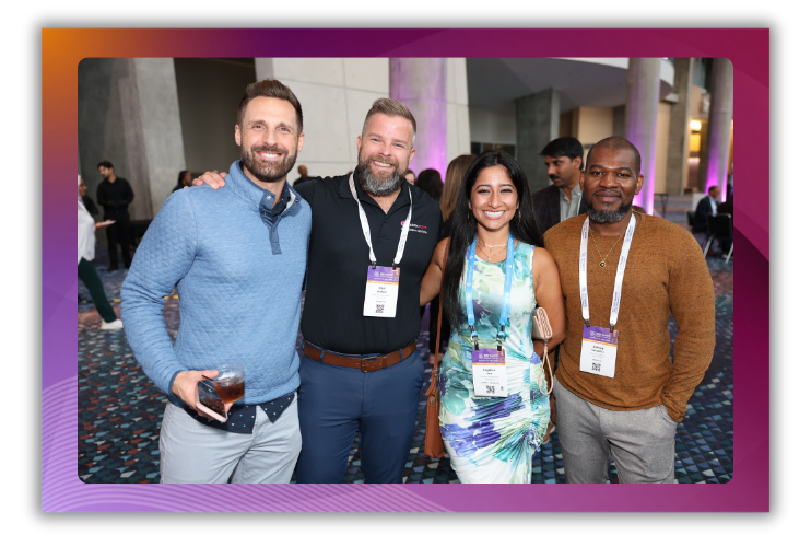 A photo of four people smiling for the camera at a networking event