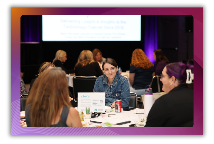 A photo of women sitting around a table talking