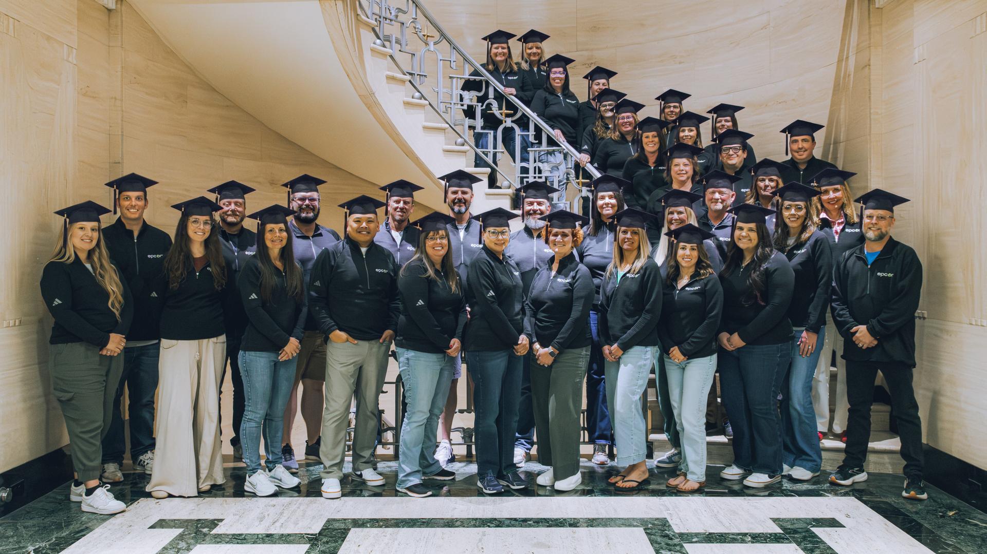 image: EPCOR staff wearing graduation caps