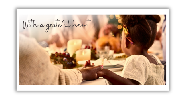 Little girl holding hands with her family around dining table. Text overlay reads, 