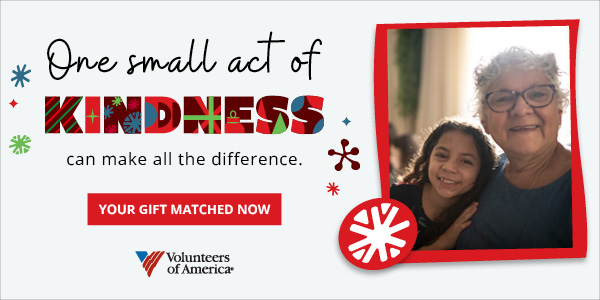 Young girl smiling for a photo with her grandmother.