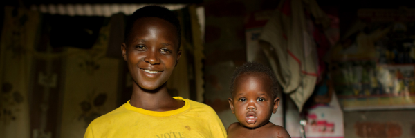 Mother and child smile at camera