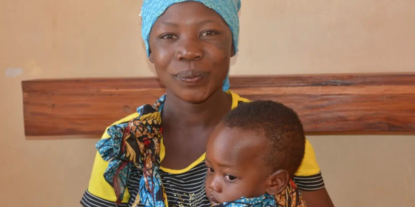 Mother and child smile at camera