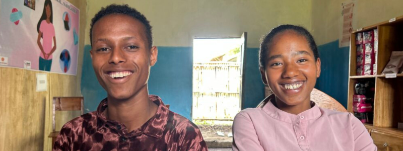 Teenagers from Ethiopia smile at the camera following an EngenderHealth Life Skills training on menstrual health and hygiene.