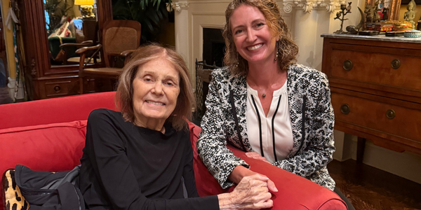 Gloria Steinem and Traci L. Baird hold hands during a conversation on menstrual health and dignity.