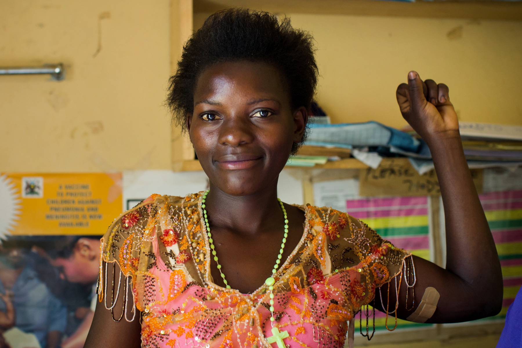 A woman proudly shows off her contraceptive implant. 