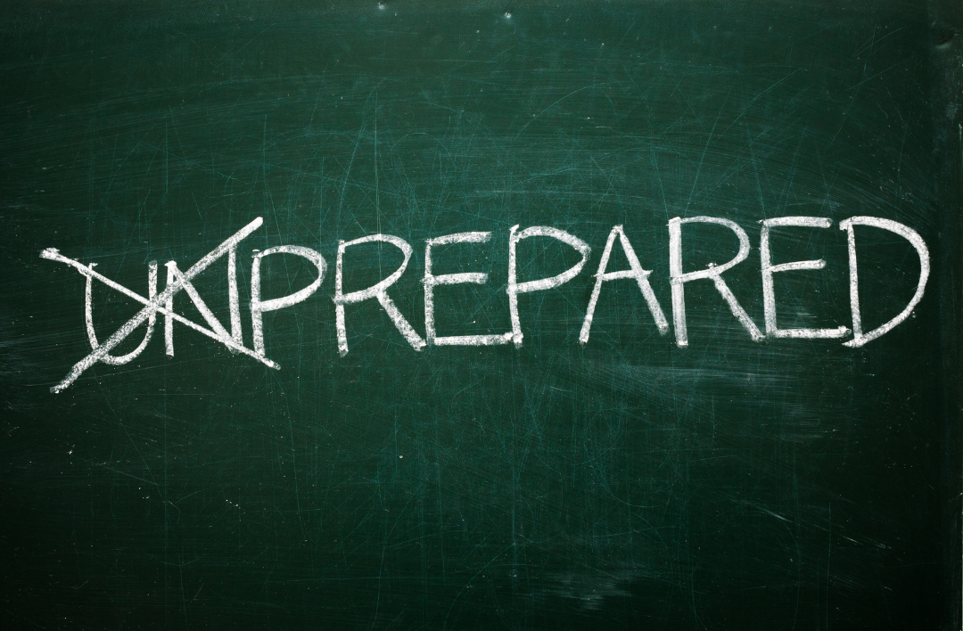 Dark green chalkboard with 'UNPREPARED' written on it, with 'UN' crossed out.