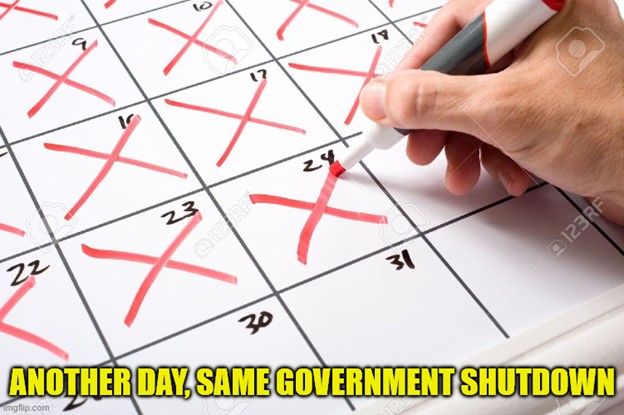 Close up of a calendar page and hand drawing large red X's through the days.