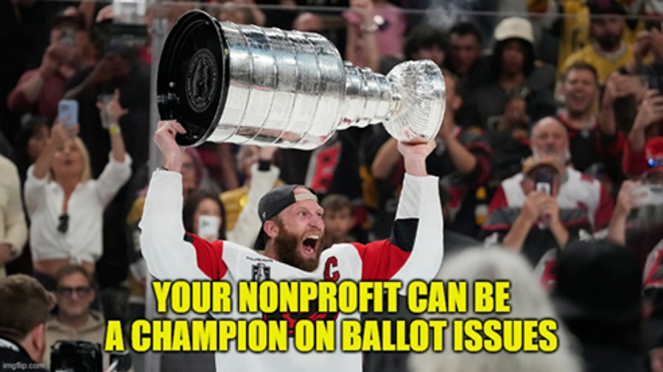 NHL Carolina Hurricanes hockey player Jordan Staal celebrating the team's 2026 championship win with a huge open-mouthed smile and waving the Stanley Cup high above his head.