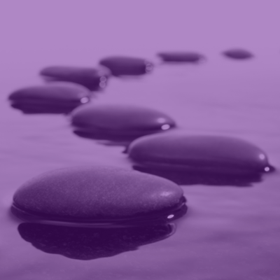 Close up of stepping stones making a path through still water.