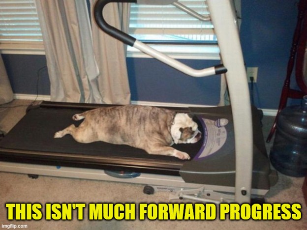 A brown dog with legs splayed out, laying down on the walking belt of a treadmill. Text reads 'This isn't much forward progress.'